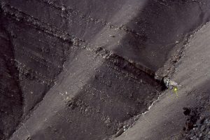 Two views (also the image below) of a lenticular, trough crossbedded pebbly sandstone that has cut into the top of a shelf cycle. This has been interpreted as a lowstand fluvial channel, that traversed and eroded the shelf as it was exposed during falling sea level.  This was one mechanism for transporting gravel and sand to the slope and deeper basin, via shelfbreak gullies (like the one pictured above).  Jurassic Bowser Basin, northern British Columbia.