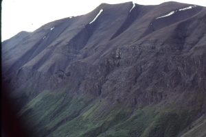 View from the center of Todagin submarine channel complex, showing the step-like stacking of successive channels. Maximum thickness of the conglomerate-fill exceeds 300m.  On this ridge, an equivalent thickness of slope mudrock overlies the canyon. Bowser Basin, British Columbia.