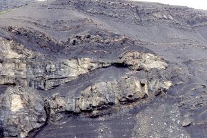 The chert-pebble conglomerate accumulated in a shelfbreak gully.  The uninterrupted transition from shale-dominated slope to shelf is located immediately to the right of the gully margin.  Jurassic Bowser Basin, northern British Columbia. Details of the gullies have been published here: Shelfbreak gullies; Products of sea-level lowstand and sediment failure: Examples from Bowser Basin, northern British Columbia. 1999,  Journal of Sedimentary Research 69(6):1232-1240