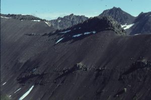 Shelfbreak gullies extend down slope. Here, two packages of channelized conglomerate (along the ridge line) occur entirely within slope facies.  The small lenses of conglomerate below are laterally discontinuous and thought to represent channel spillover lobes. Joan Lake, Bowser Basin, British Columbia.