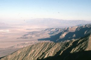 Death Valley, looking north from Dante's View - the fault block here lies immediately east of Panamint Range.  Alluvial fans merge with the salt flats. The dimly visible whitish area in the distance is Mesquite Flat sand dunes, near Stovepipe Wells.