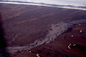 Part of a large, coastal (humid-cold) alluvial fan complex along the north coast of Yukon (west of MacKenzie River delta).  The active channel at this time was itself, a largish braided river. Field of view across the coastline is about 3 km.