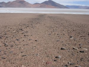 ooking down-slope along inactive parts of fans.  Left image shows levees of cobbles and boulders deposited by a debris flow. Atacama, northern Chile. Eocene and younger volcanic edifices in the distance.