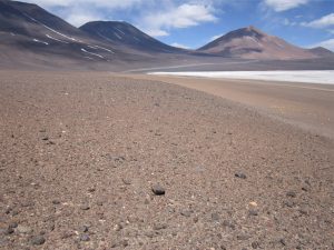 View of an alluvial fan, approximately along strike. Eocene and younger volcanic cones in the background were part of the caldera system that gave rise to the salar basins. Alti Plano, northern Chile.