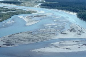 More detailed view of active mid-channel bars, channels, and chutes on Bonnet Plume River (Yukon). Dark grey patches on the bar tops are accumulations of wood and plant debris probably captured during the falling stage of river levels. The sediment is a mix of sand and gravel.