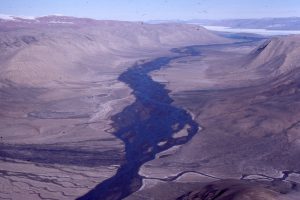 Several, small alluvial fans merge with the braided stream that drains into the south end of Canon Fiord, Ellesmere Island.  Potential paleoflow directions in the fans would be oriented about 90 degrees to indicators in the braided river. This is an arid setting, with most flow during spring and early summer thaw.