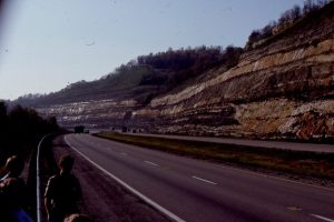 A classic Kentucky Carboniferous highway exposure of channel sandstone cutting into floodplain siltstone-mudstone and thin overbank sandstone. This is overlain by point-bar accretionary foresets (building away from viewer).  Mostly upper delta plain.