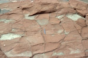 Reddened (iron oxides), desiccated mudrocks interbedded with channelized sandstone in the Proterozoic Loaf Fm, Belcher Islands; proof that the level of oxygen in the ancient atmosphere had increased to the point where ferric iron was stable.