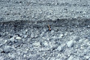 Incision of a gravel-sand flow unit on the alluvial fan that merges with Peel River (image above). Deposition as bedload was probably generated by stream flood.