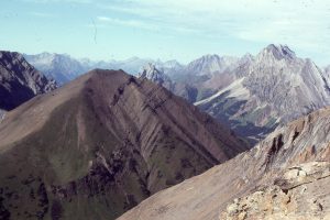 Lower Cretaceous foreland basin strata (foreground) involved in a later phase of thrusting. View is to the north of Highwood Pass. Lewis Thrust charges down the valley beyond. Front Ranges, Alberta Foreland basin.