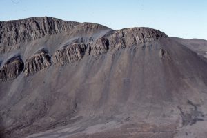 Diabase sills intrude Jurassic through Permian successions in the Arctic Sverdrup Basin. Unroofing of these older rocks during the Eurekan Orogeny (climaxing about mid Eocene) provided large volumes of coarse sediment to alluvial fans, braided and high sinuosity rivers. The Stolz Thrust is at the base of slope, with tectonic transport to the right (east).