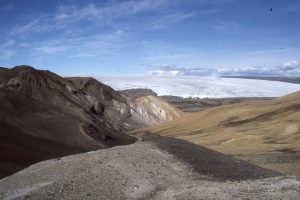 Panorama of Jurassic-Triassic rocks above Stolz Thrust (rugged left side of view) over pale brown syntectonic conglomerate at Geodetic Hills (Buchanan Lake Fm.), Axel Heiberg Island