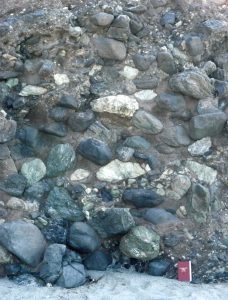 Four stacked. bouldery debris flows, with mixed clast- and matrix-supported frameworks; flow units are delineated by fairly abrupt changes in grain size. The matrix is mostly mud. Framework grain size range is from boulder to sand. Clast compositions include metamorphic and intrusive igneous rocks. Dana Point, California.