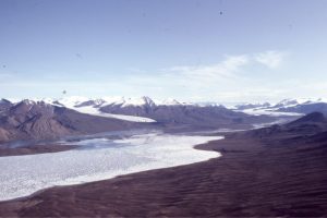 The head of Strand Fiord, Axel Heiberg Island, contains a braid-plain fan delta (center), the outwash drainage from Strand Glacier (distant right). A smaller, 'radial' fan delta is growing along the south (right) fiord shore.  See image below for a different perspective of this fan delta.