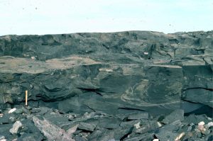 As river deposits settle and consolidate, the water between grains is forced out by the weight of the sediment (this is called dewatering). The process commonly disrupts and contorts the sedimentary laminae, forming structures that superficially resemble pillows; these structures are given the general name ball and pillow.  Loaf Fm. Belcher Islands (about 1.8-2 billion years old).