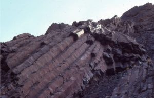 Strand Fiord volcanics, an Upper Cretaceous unit on Axel Heiberg Island, Canadian Arctic. Here an 'organ-pipe' array of columnar joints (4m high) have perforated the basalt during cooling. Cross-joints are also present.