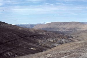 Panorama of Lower Paleocene basal sandstones (left) in unconformable contact with Ordovician limestones - the contact coincides with the stream bed. Ellesmere Island.