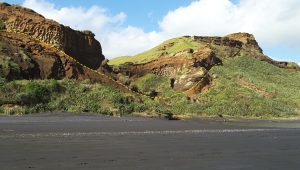 The Pleistocene paleovalley margins (outlined) that eroded shallow coastal marine and dune sands, are overlain by younger dune sands. The modern valley has cut into both of generations of Pleistocene dunes. Kariotahi, west Auckland.