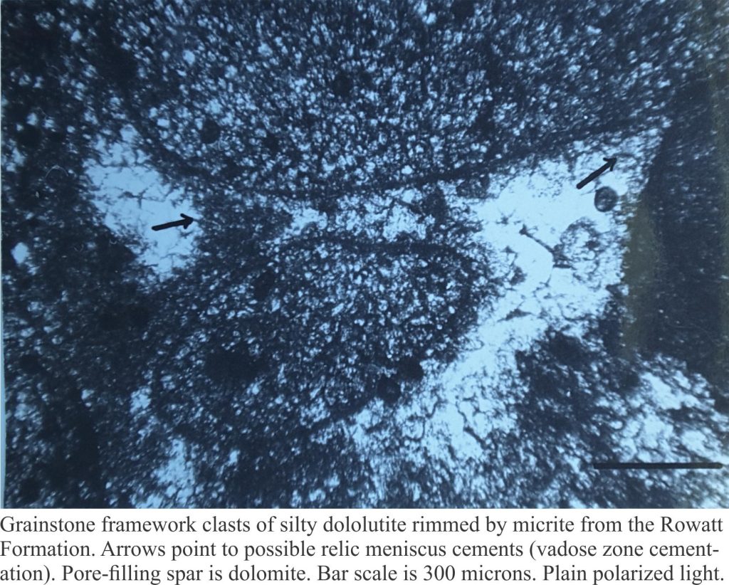 Thin section micrograph of dolomicrite rinds on grainstone clasts; the coarse spar cement is dolomite