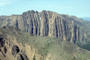 An impressive stack of Upper Jurassic fan deltas in Bowser Basin, northern British Columbia. Each delta package is separated by recessive, interfan turbidites and mudstone. The stack accumulated during active faulting close to the basin margin. Icebox Canyon.