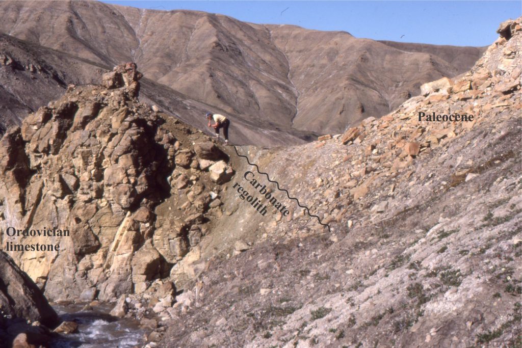 Estuarine deposits, paleosols, blocky regoliths and karst paleotopography (Expedition Fm, Eureka Sound Group) developed on deformed Ordovician to Devonian carbonates and siliciclastics, heralding renewed subsidence and stratigraphic onlap across Sverdrup Basin. The angular unconformity between Ordovician carbonates and Early Paleocene estuarine mudrocks is underlain by regolith. Fractured limestone is arranged in jig-saw fit patterns; there is no evidence of reworking – shown in the image following. The unconformity is overlain by estuarine mudstone, sandstone and thin coals, and locally tidal channel sandstones. Expedition Fm. Mount Moore, Ellesmere Island.