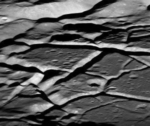 Intense fracturing across the floor of Komarov crater is probably due to post-impact magma intrusion. Bedrock fracturing like this is likely responsible for seismic wave scattering in the upper crust. Field of view is 15 km wide (the crater is 85 km in diameter). Image acquired by the Lunar Reconnaissance Orbiter, 2018. Image credit: NASA/GSFC/Arizona State University.